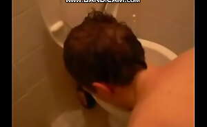 young guy licks toilet