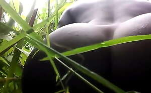 native African dildo masturbating in the jungle