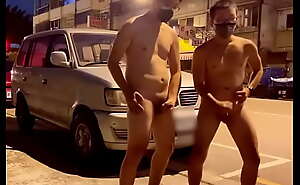 Two Asians cum on the street